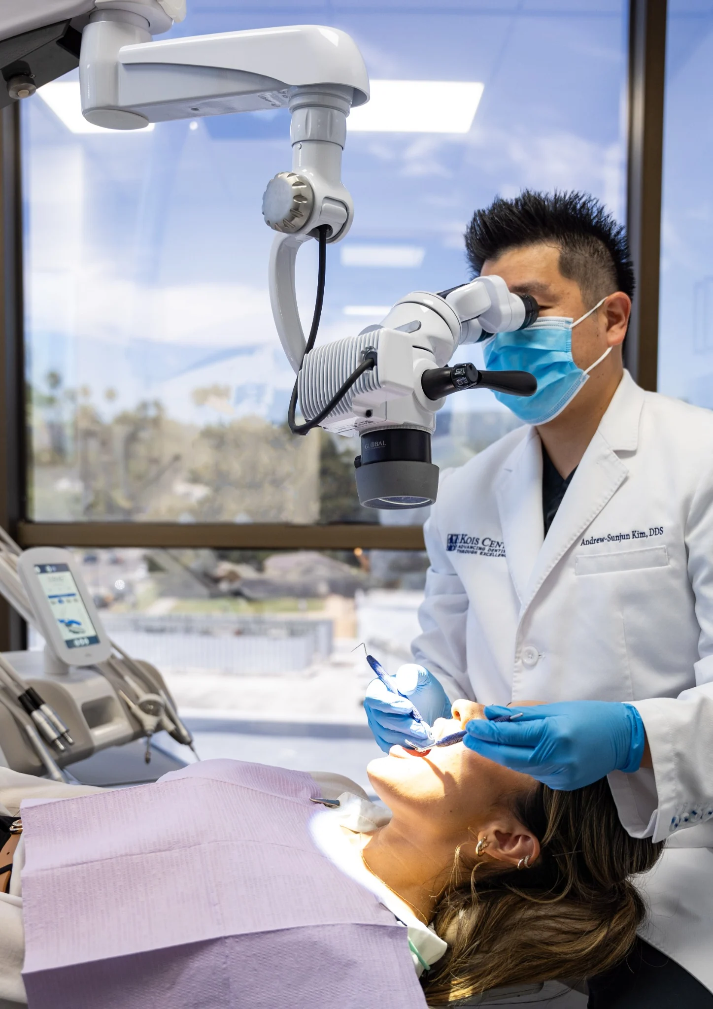 Dr. Kim using a dental microscope